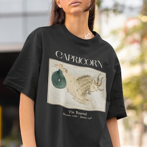 May include: Black t-shirt with a vintage illustration of the Capricorn constellation. The text "Capricorn" and "The Reserved" are printed on the shirt. The dates "December 22nd - January 19th" are also printed on the shirt.