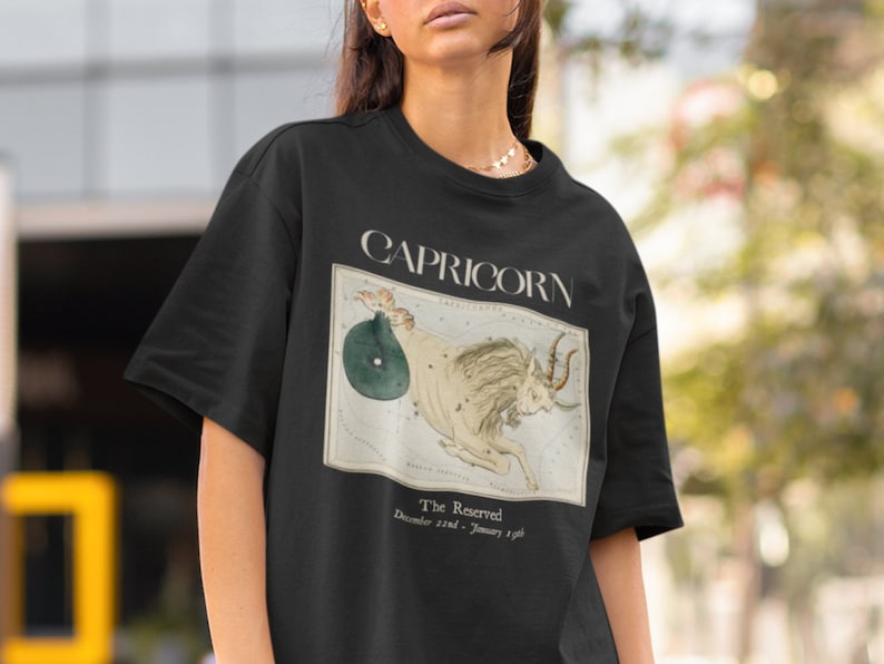 May include: Black t-shirt with a vintage illustration of the Capricorn constellation. The text "Capricorn" and "The Reserved" are printed on the shirt. The dates "December 22nd - January 19th" are also printed on the shirt.