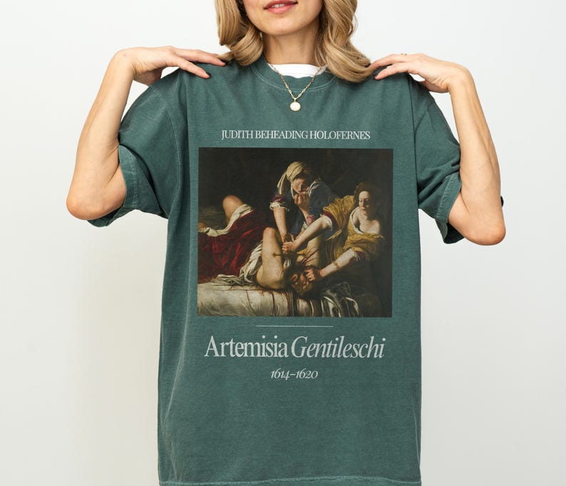 May include: A dark green t-shirt with a painting of Judith Beheading Holofernes by Artemisia Gentileschi (1614-1620).