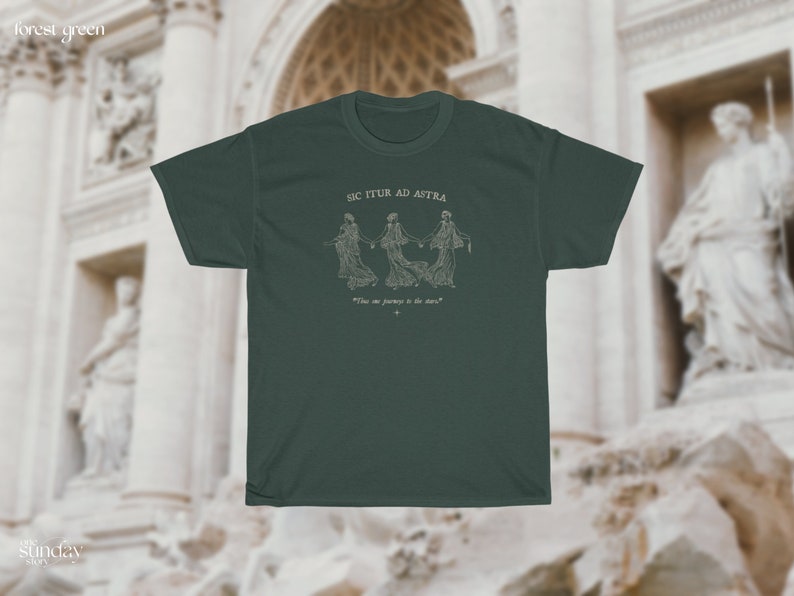 May include: A forest green t-shirt with a white graphic of three figures holding hands and the text "Sic Itur Ad Astra" and "The one journey is the dare".