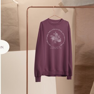 May include: Maroon sweatshirt with a floral design and the text "Love is forever, always, one sweet thing" in a circle around the design.