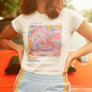 May include: White t-shirt with a colorful abstract design and the text "Psychedelic Series", "Retrospective", "Gallery Exhibition", and "4070s".