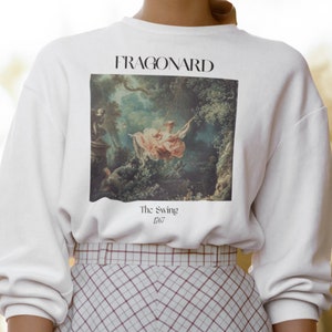 May include: White sweatshirt with a print of a painting by Fragonard, "The Swing" 1767.