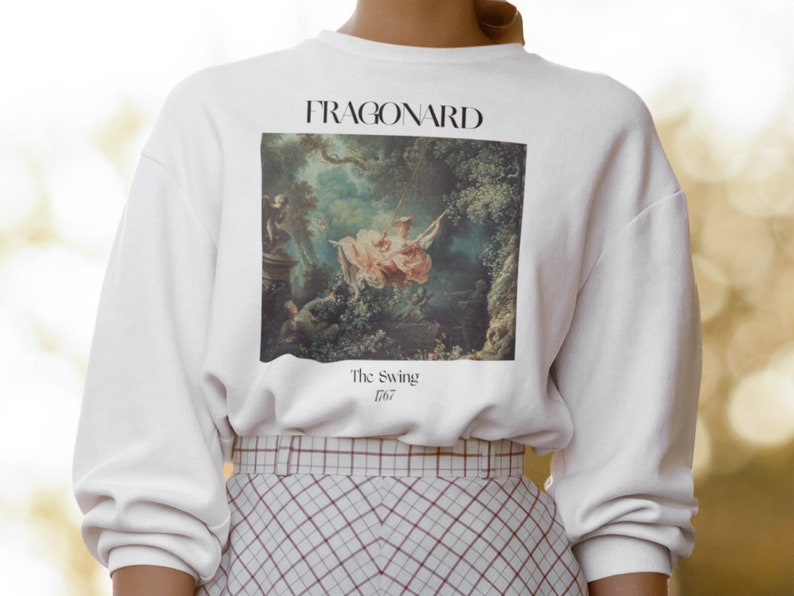 May include: White sweatshirt with a print of a painting by Fragonard, "The Swing" 1767.