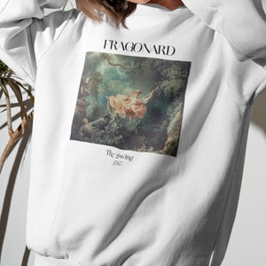 May include: White sweatshirt with a print of a painting by Jean-Honor&eacute; Fragonard titled "The Swing" from 1767.