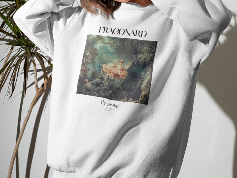 May include: White sweatshirt with a print of a painting by Jean-Honor&eacute; Fragonard titled "The Swing" from 1767.