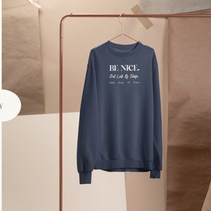 May include: Navy blue sweatshirt with the text "BE NICE. Get Lots of Sleep. Drink Plenty of Water." printed in white.