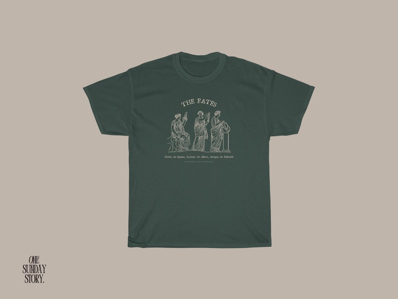 May include: A dark green t-shirt with a white graphic of three figures labeled "The Fates". The text below the figures reads "Clotho, the spinner, Lachesis, the allotter, Atropos, the inevitable".