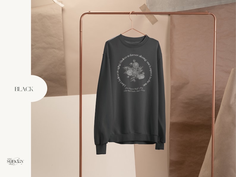 May include: Black sweatshirt with a white floral design and the text "Love like forever, always, over and over again.  Joy Blooms Wild, 2019."