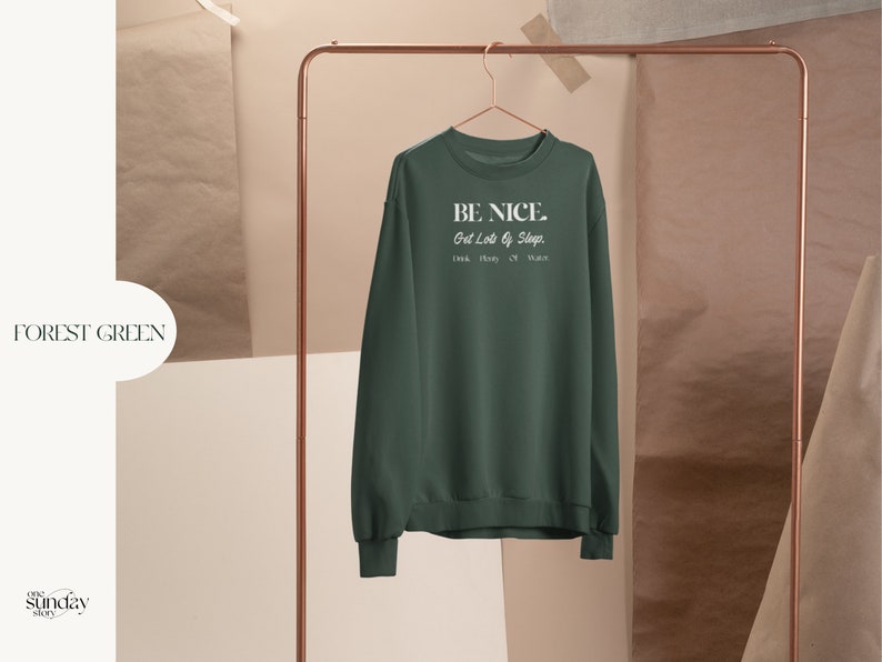 May include: Forest green sweatshirt with the text "BE NICE. Get Lots of Sleep. Drink. Play. Or Dance." in white.