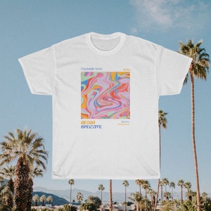 May include: White t-shirt with a psychedelic design featuring swirling colors of pink, blue, yellow, and green. The text "Psychedelic Series" and "Retrospective" is printed on the shirt.