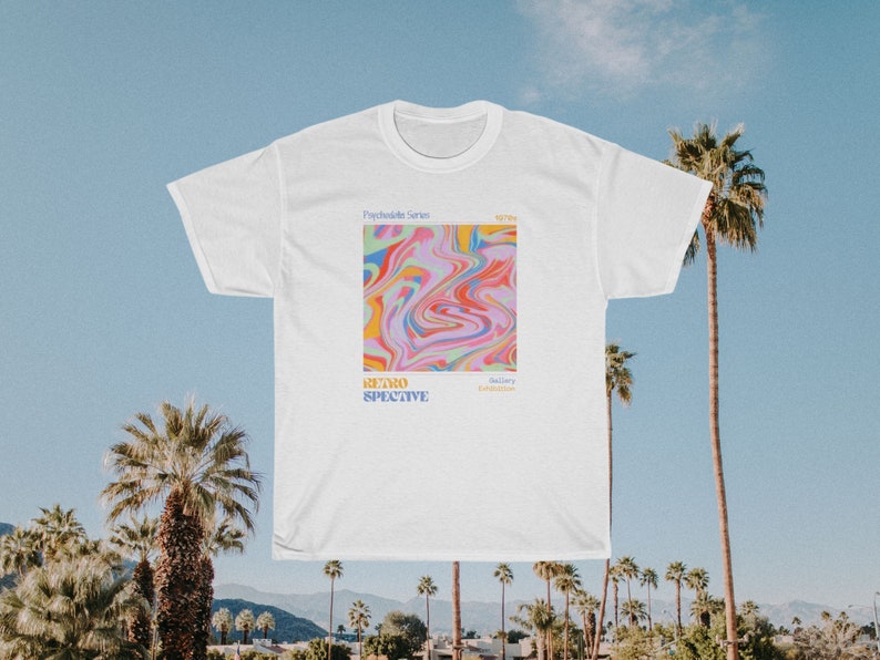 May include: White t-shirt with a psychedelic design featuring swirling colors of pink, blue, yellow, and green. The text "Psychedelic Series" and "Retrospective" is printed on the shirt.
