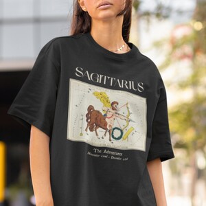 May include: Black t-shirt with a vintage illustration of the Sagittarius constellation and the text "Sagittarius, The Adventurer, November 22nd - December 21st."