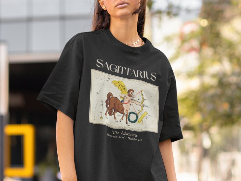 May include: Black t-shirt with a vintage illustration of the Sagittarius constellation and the text "Sagittarius, The Adventurer, November 22nd - December 21st."