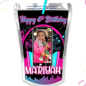 May include: A personalized juice box with a black background and a pink and blue musical note design. The juice box features a photo of a young girl holding a stuffed animal. The text "Happy 6th Birthday" and the name "MARIYAH" are printed on the juice box.