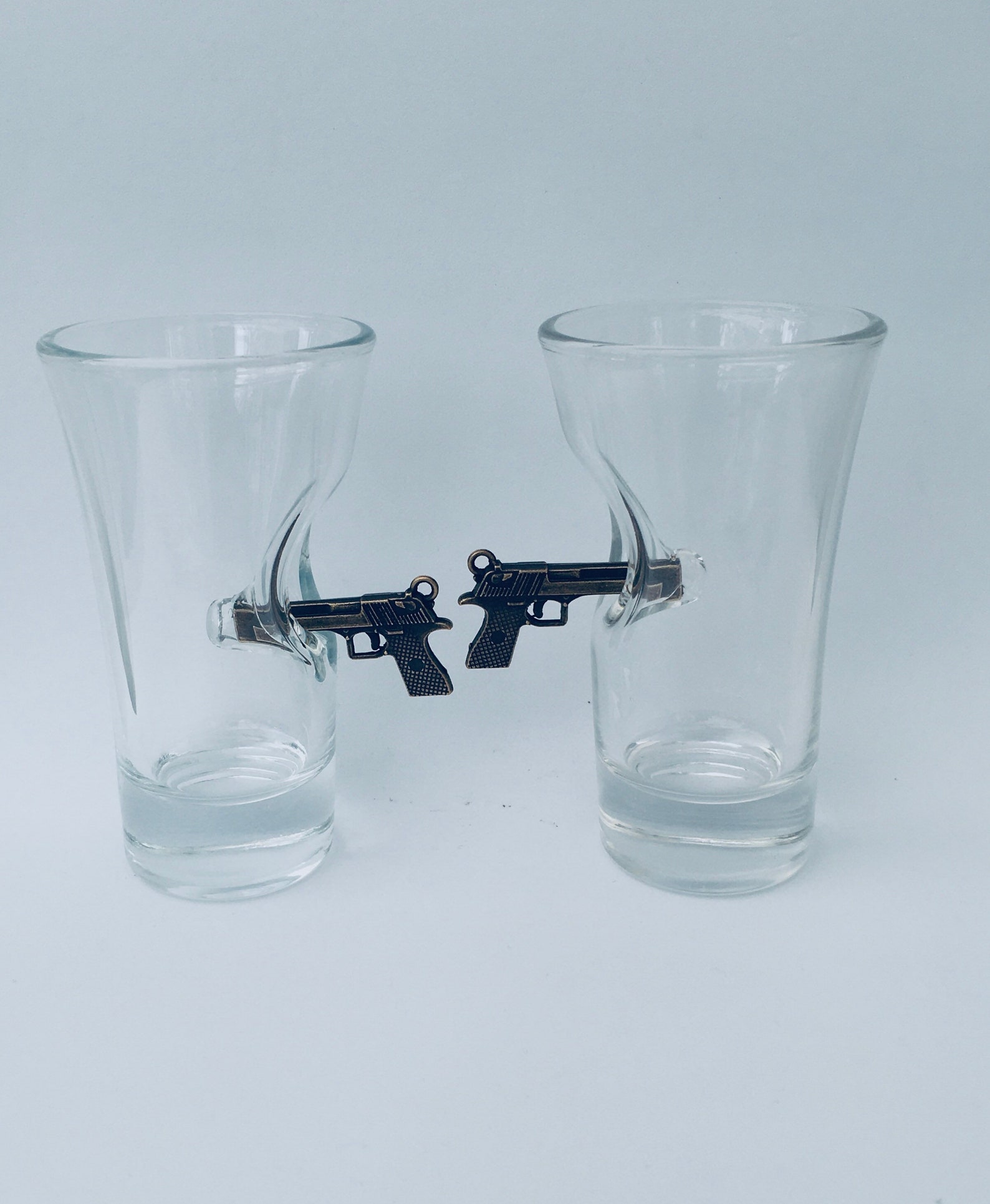 Shot Glasses with a mini bronze hand gun embedded into the Etsy