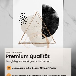 May include: Abstract art print with a black circle, gold triangle, and black and white dots on a white background. The print features the text "MADE IN GERMANY" and "Premium Qualit&auml;t". The text below the title reads "Langlebig, robust & gestochen scharf."  The print also includes the text "gedruckt auf extra dickem 400 g/m&sup2; Papier" and "mattes Finish mit scharfen Details & kr&auml;ftigen Farben".