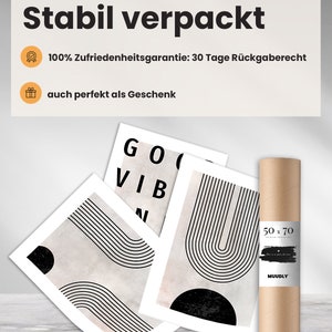 May include: A collection of art prints with abstract black and white designs, including the words "GOOD VIBES". The prints are displayed with a rolled-up poster in a brown tube, labeled "50 x 70". The packaging is labeled "Stabil verpackt".