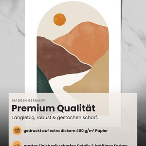 May include: Abstract art print featuring a landscape with mountains, a river, and a sun in a peachy orange color. The print has a matte finish and is printed on thick paper.