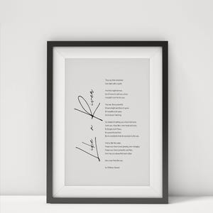 May include: A framed print with a black frame. The print features a poem with the words "Life a River" in cursive. The poem is in black text on a white background. The print is displayed on a white surface.