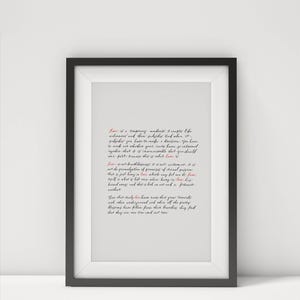 May include: Framed art print with a black frame, featuring a handwritten poem about love in black and red ink. The text is centered on a white background, creating a minimalist aesthetic.