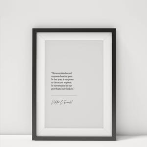 May include: A framed print with a black frame and white matting. The print features a quote by Viktor E. Frankl in black text on a white background. The quote reads: "Between stimulus and response there is a space..."