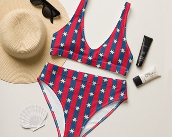 May include: Red and blue striped bikini with white stars. The bikini top has a scoop neck and the bottoms are high waisted.