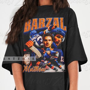 May include: Black oversized t-shirt with a vintage graphic print of a hockey player wearing a blue and orange jersey with the name "Barzal" and the number "13" on the back. The text "Mathew" is printed below the graphic.