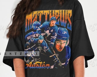 May include: Black oversized t-shirt with a vintage graphic print of hockey players. The graphic features the text "MATTHEWS" and "Auston".