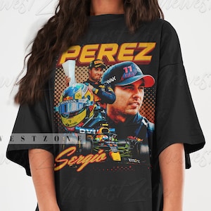 May include: A black t-shirt with a graphic print of a Formula One race car driver, Sergio Perez, wearing a red bull racing helmet and racing suit. The text "Perez" and "Sergio" are printed on the shirt.