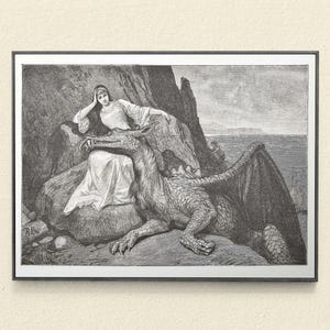 May include: Black and white framed print of a woman and a dragon. The woman is seated on a rock, wearing a long dress and resting her head on her hand. A dragon is lying down next to her, with its head near the woman.