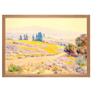 May include: A painting of a landscape with a winding road leading through a field of yellow wildflowers. The sky is a pale blue and the hills in the distance are a soft purple. The painting is framed in a light wood frame.