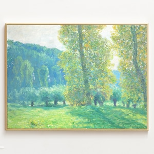 May include: A painting of a landscape with a field of green grass and trees in the background. The trees are a mix of green and yellow, and the sun is shining through the leaves. The painting is framed in a gold frame.