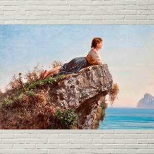 May include: A woman in a blue and white dress sits on a rocky cliff overlooking a body of water. The woman is looking out at the water, and the sky is a light blue.