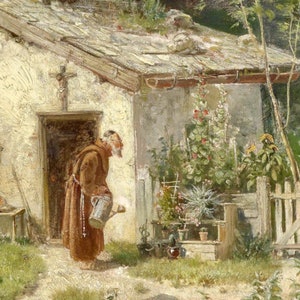 May include: A man in a brown robe waters plants in a garden outside a small white house. The man is holding a watering can and has a rosary around his neck. The house has a wooden roof and a small wooden fence in the garden.
