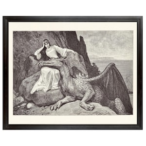 May include: A framed black and white print depicting a person in a long gown resting on a rock beside a large, winged dragon. The scene includes a rocky landscape, a distant sea, and a small ship. The artwork is enclosed in a dark wooden frame.