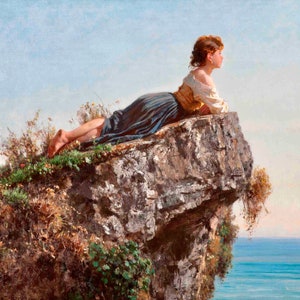 May include: A woman in a blue and brown dress lies on a rocky cliff overlooking a blue sea. The sky is a light blue with white clouds.