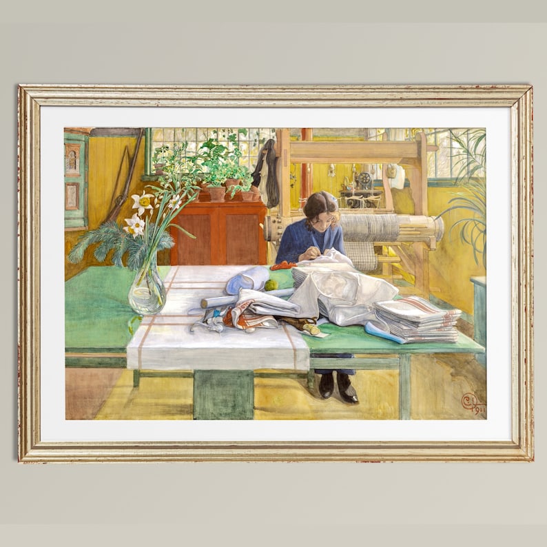 May include: A woman sits at a table in a sunlit room, sewing a white fabric. The table is covered with a white tablecloth and surrounded by various sewing supplies, including spools of thread, scissors, and fabric scraps. A loom is visible in the background, along with a potted plant and a vase of daffodils.