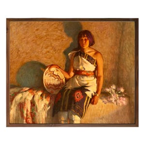 May include: Oil painting of a person in traditional Native American attire, holding a patterned basket. The artwork features warm tones, with a focus on the subject's clothing and the basket's intricate design. The painting is framed in a wooden frame.