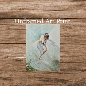 May include: An unframed art print featuring a watercolor painting of a figure in flowing blue garments, with a light blue scarf and wings. The figure is in a pose of being in the rain. The text "Unframed Art Print" is at the top.