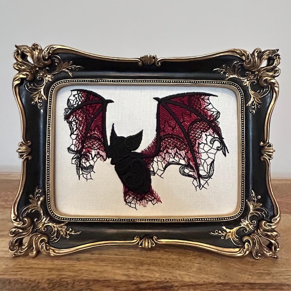 Black and red lace bat embroidery art framed in a distressed gold and black vintage gothic picture frame