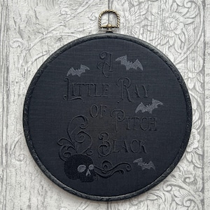 A Little Ray of Pitch Black,  Embroidered Hoop - Finished hoop with a moody, skull-and-bats embroidery for Halloween vibes all year long.