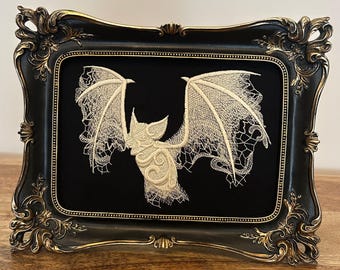 White lace bat embroidery art framed in a distressed gold and black vintage gothic picture frame. Gothic décor wall hanging, dark moody