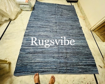 May include: A blue and white striped rug made from recycled denim. The rug has the text "Rugsvibe" printed in white on it.