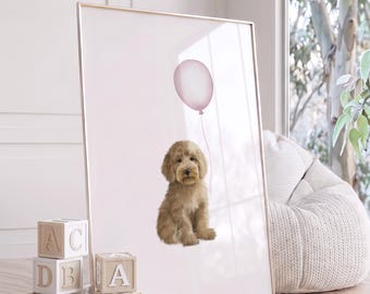 May include: A framed vertical wall art print featuring a light brown, fluffy puppy sitting upright. Above the puppy, a single pale pink balloon is attached by a thin string. The background of the print is a solid, soft pastel pink color.