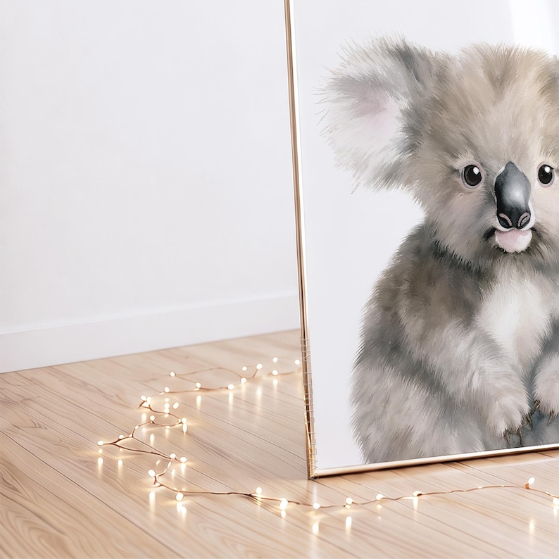 May include: A framed wall art print featuring a detailed illustration of a fluffy koala with grey and white fur, large ears, and a black nose. The koala is depicted from the chest up against a plain white background, captured in a portrait orientation.