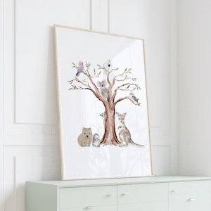 May include: A vertical rectangular wall art print in a light wood frame featuring a watercolor illustration of a brown tree populated with Australian animals including a koala, kangaroo, wombat, echidna, galah, cockatoo, and kookaburra.