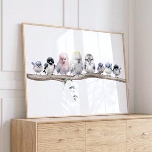 May include: A framed horizontal wall art print featuring a watercolor illustration of eight diverse birds perched on a single brown tree branch. The birds include various species with soft grey, pink, white, and blue plumage against a white background.