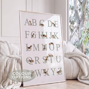 May include: A vertical rectangular wall art print featuring the English alphabet in large, light gray serif letters. Each letter is accompanied by a small, realistic illustration of a beagle puppy in various poses, set against a light background.