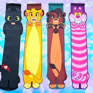 May include: Four colorful fabric wall banners featuring cartoon characters. The banners are black, yellow, brown, and pink with white stripes. The characters are a black dragon, a yellow lion, a brown lion, and a pink cat.